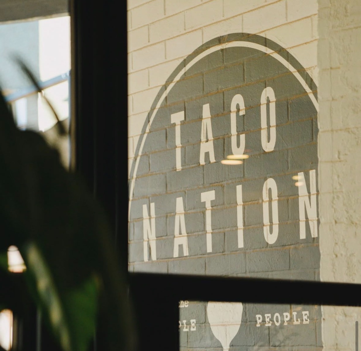 Taco Nation sign on brick